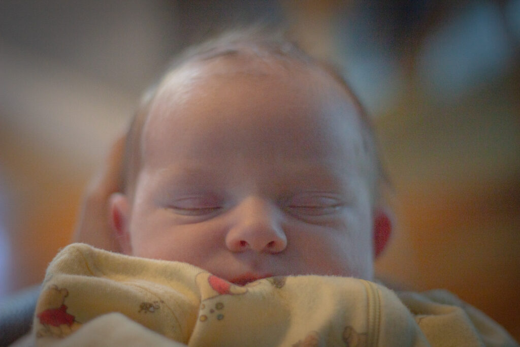 Peaceful newborn sleeping captured in a fresh 48 photography session, documenting the delicate features of baby’s earliest hours.
