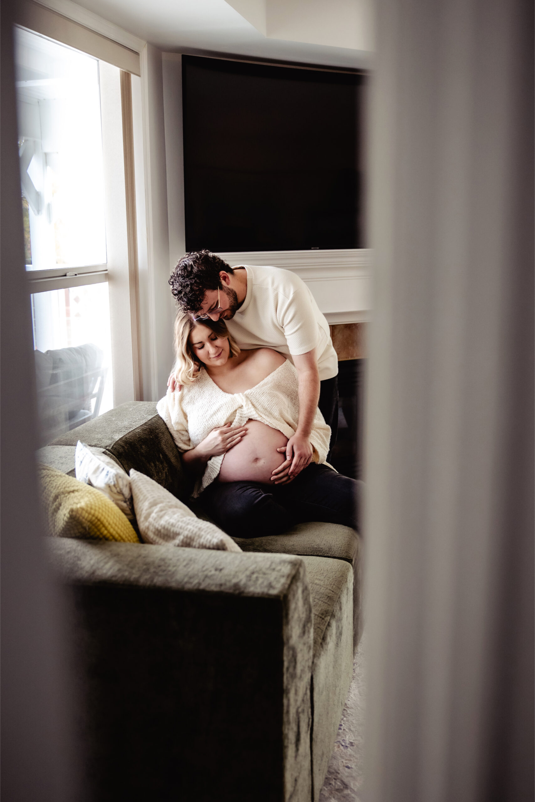 Warm, cozy embrace captured during at home maternity photos in Edmonton, celebrating connection and love before baby’s arrival.
