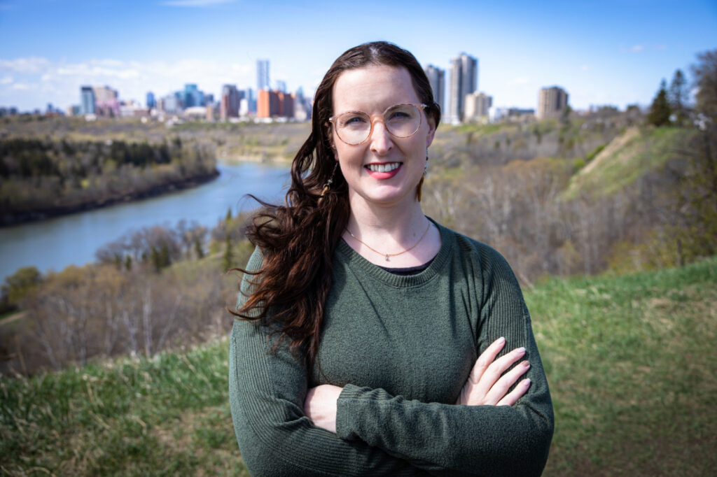 Birth professional photographed outdoors overlooking Edmonton’s river valley, representing the trusted care provided by Edmonton doulas and midwives.